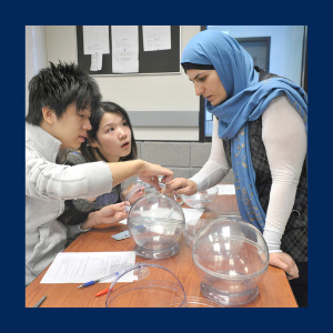 three students working together to solve a problem.